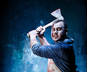 Image showing Bloody Halloween theme: crazy killer as butcher with an ax