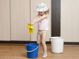 Image showing Little girl wash rag in the bucket