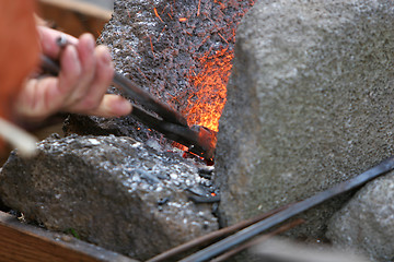 Image showing stoking the fire