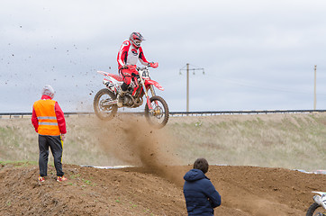 Image showing Volgograd, Russia - April 19, 2015: Spectators watch as the racers bouncing on the trampoline on stage the Open Championship motorcycling Cup cross-country Volgograd Region Governor