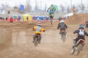 Image showing Volgograd, Russia - April 19, 2015: A few riders in pursuit of the leader, at the stage of the Open Championship Motorcycle Cross Country Cup Volgograd Region Governor