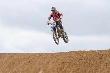 Image showing Volgograd, Russia - April 19, 2015: Motorcycle racer jumps a hill, at the stage of the Open Championship Motorcycle Cross Country Cup Volgograd Region Governor