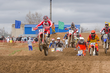 Image showing Volgograd, Russia - April 19, 2015: Motorcycle racer after the start of driving on the road by a large group, at the stage of the Open Championship Motorcycle Cross Country Cup Volgograd Region Govern