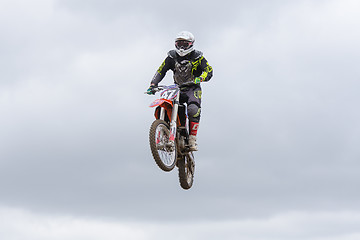 Image showing Volgograd, Russia - April 19, 2015: Motorcycle racer in flight, at the stage of the Open Championship Motorcycle Cross Country Cup Volgograd Region Governor