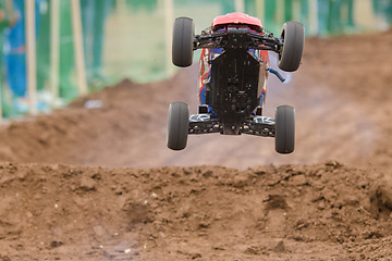 Image showing Volgograd, Russia - April 19, 2015: Radio-controlled machine with a combustion engine has jumped on the trampoline