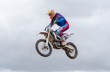 Image showing Volgograd, Russia - April 19, 2015: Motorcycle racer flying jumping on the trampoline, on the stage of the open championship motorcycling Cup cross-country Volgograd Region Governor