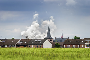 Image showing Village with ugly coulds in background