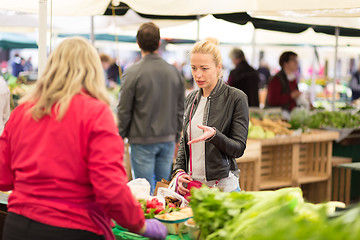 Image showing Woman buying vegetable at local food market. 