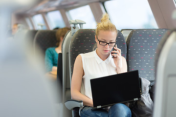 Image showing Business woman working while travelling by train.