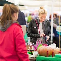 Image showing Woman buying vegetable at local food market. 