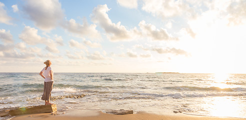 Image showing Free Happy Woman Enjoying Sunset on Sandy Beach