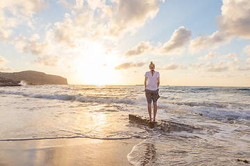 Image showing Free Happy Woman Enjoying Sunset on Sandy Beach