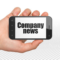 Image showing News concept: Hand Holding Smartphone with Company News on display