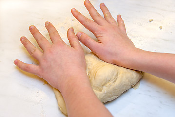 Image showing Hands knead dough