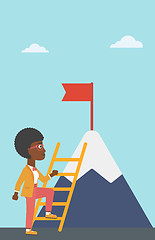 Image showing Business woman climbing on mountain.