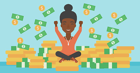 Image showing Happy business woman sitting on coins.