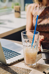 Image showing Defocused woman using tablet in cafe