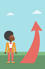 Image showing Business woman looking at arrow going up.