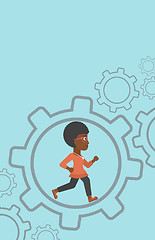 Image showing Business woman running inside the gear.