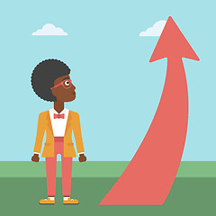Image showing Business woman looking at arrow going up.