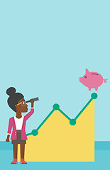 Image showing Business woman looking at piggy bank.