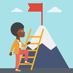 Image showing Business woman climbing on mountain.