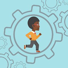 Image showing Businessman running inside the gear.