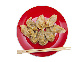 Image showing Dumplings on the red plate isolated on the white background