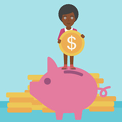 Image showing Business woman putting coin in piggy bank.