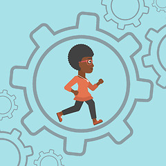 Image showing Business woman running inside the gear.