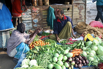 Image showing Tribal villagers bargain for vegetables. Sonakhali, West Bengal, India