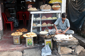 Image showing Vendor sits in lotus position, Sonakhali, West Bengal, India