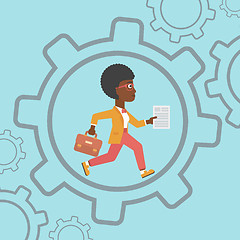 Image showing Business woman running inside the gear.