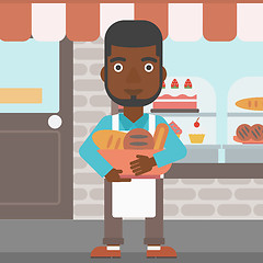 Image showing Baker holding basket with bakery products.