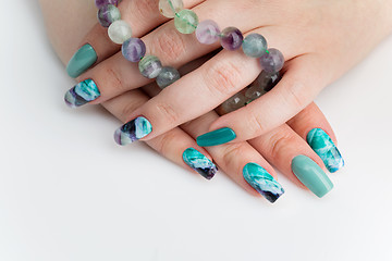 Image showing Closeup of woman hands with colorful nails