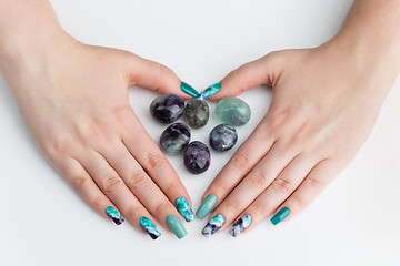 Image showing Closeup of woman hands with colorful nails