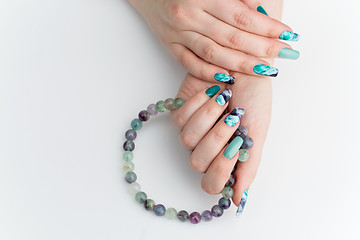 Image showing Closeup of woman hands with colorful nails