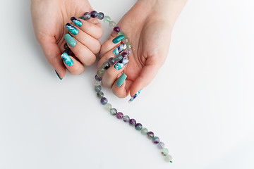 Image showing Closeup of woman hands with colorful nails