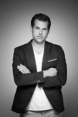 Image showing Portrait of a smart young man standing with arms crossed.