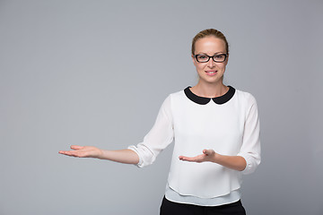 Image showing Business woman showing hand sign to side.