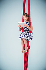 Image showing Graceful gymnast sitting with laptop