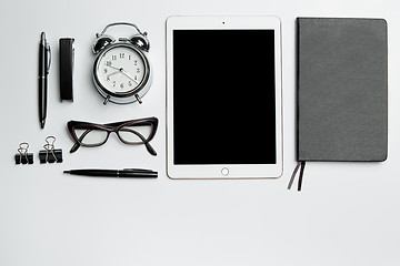 Image showing Office desk table with laptop, supplies, phone and coffee cup.