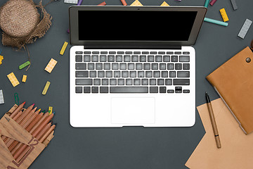 Image showing Office desk table with computer, supplies, flowers