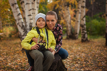 Image showing Woman and her son with camera
