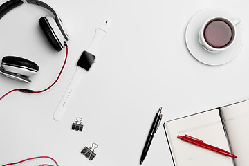 Image showing The cup, pen, and headphones on white background