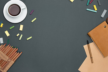 Image showing Office desk table with pencils, supplies and cup