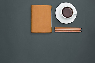 Image showing Office desk table with pencils, notebook and a cup of coffee