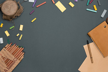 Image showing Office desk table with pencils, supplies and cup