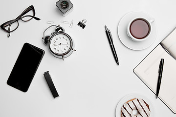 Image showing Office desk table with cup, supplies, phone on white background