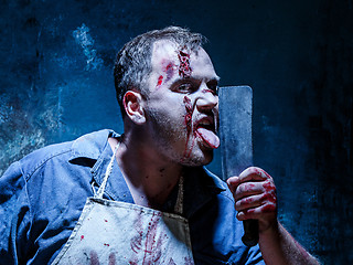 Image showing Bloody Halloween theme: crazy killer as butcher with a knife